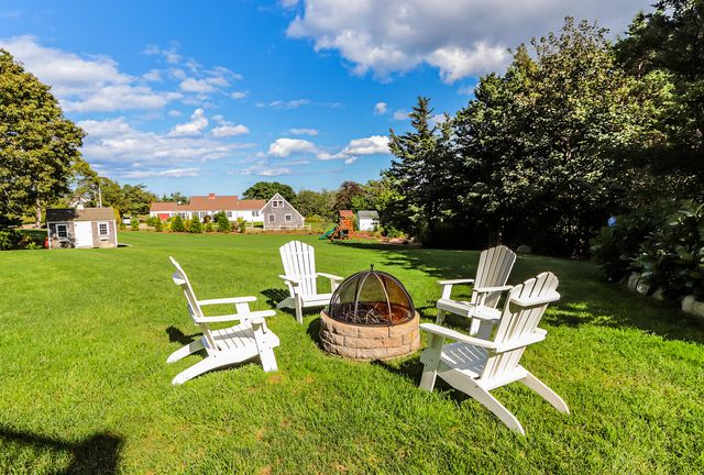 a couple of chairs and a table in the garden