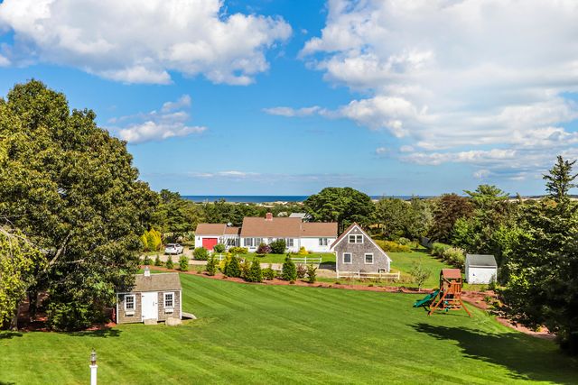 a view of a garden with a house