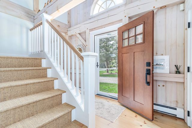 a view of entryway and hall with wooden floor