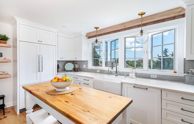 a kitchen with a stove a sink and a refrigerator