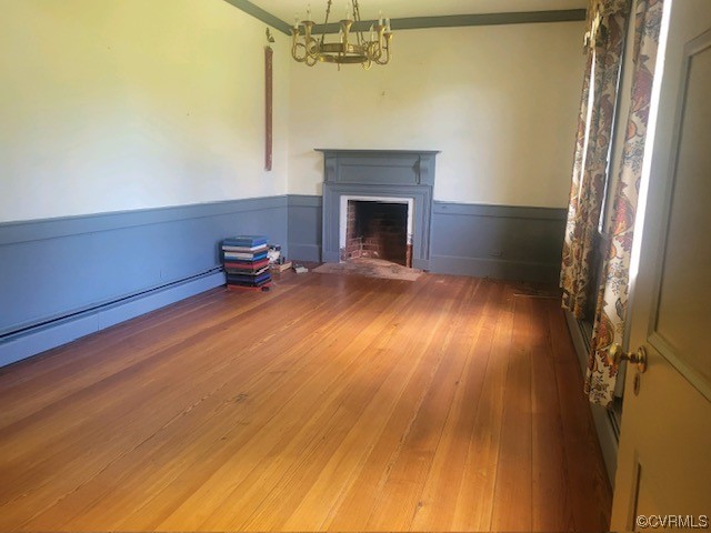 3922 Courtland Road Disputanta, VA 23842 - Photo 7 of 22 a view of empty room with wooden floor and fireplace