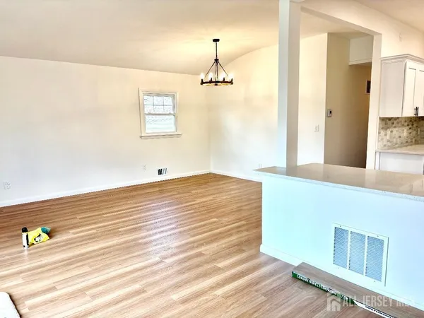 a view of a room with wooden floor and cabinet