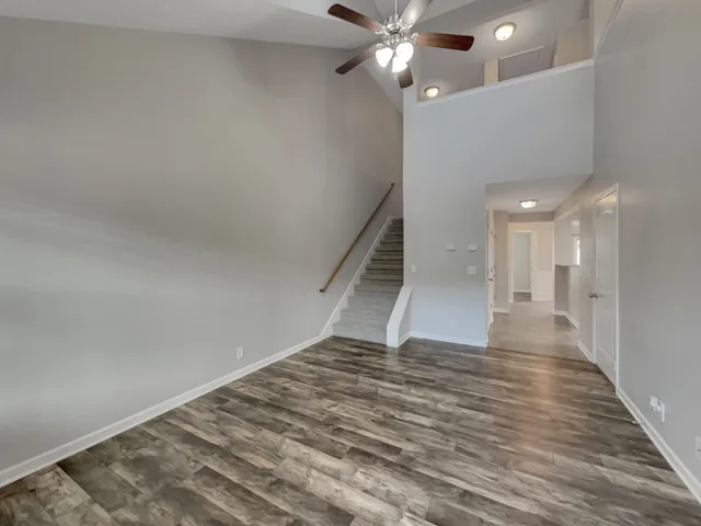a view of an empty room with wooden floor