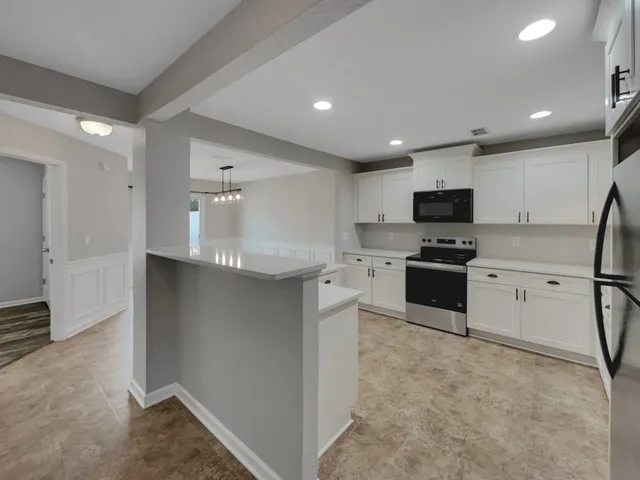 a kitchen with granite countertop a sink stainless steel appliances and cabinets