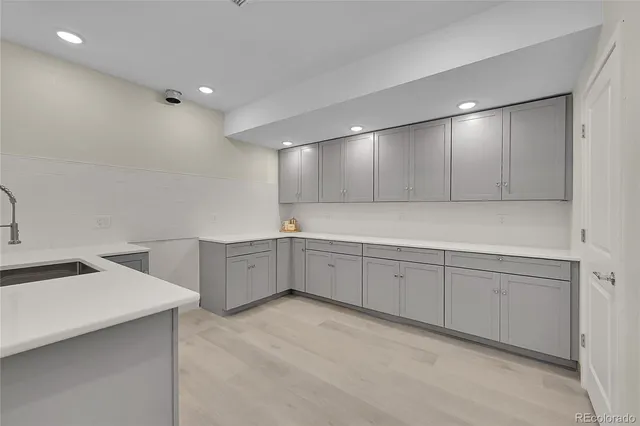 a large white kitchen with cabinets
