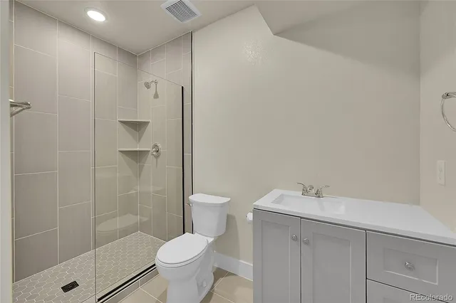 a bathroom with a shower toilet and sink