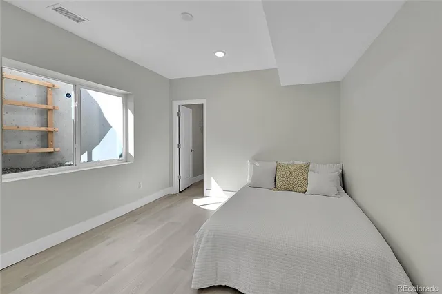 a bedroom with a bed and window