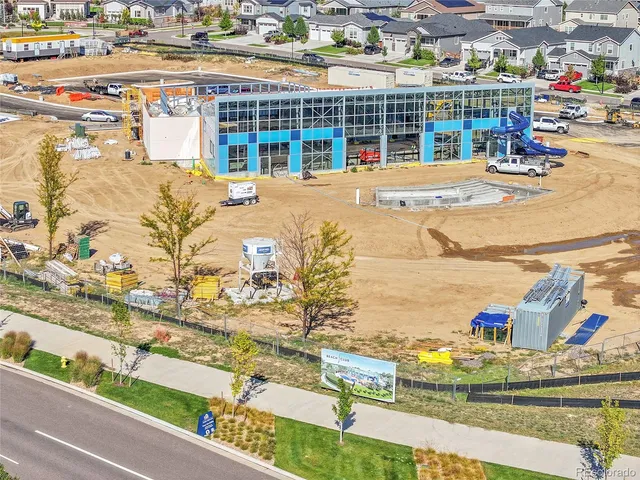 a view of residential houses with outdoor space and ocean view