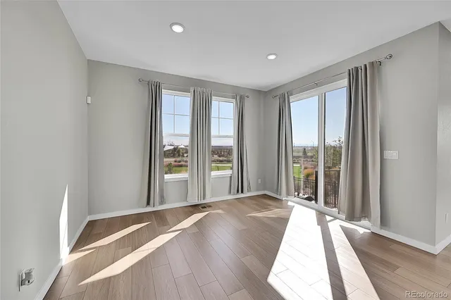 a spacious bedroom with a large bed and a large window