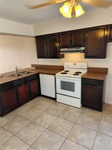a kitchen with stainless steel appliances a stove a sink and a microwave