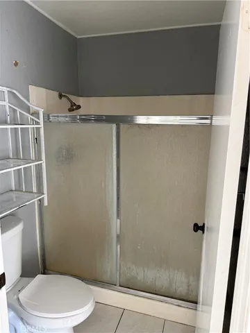 a bathroom with a toilet and shower