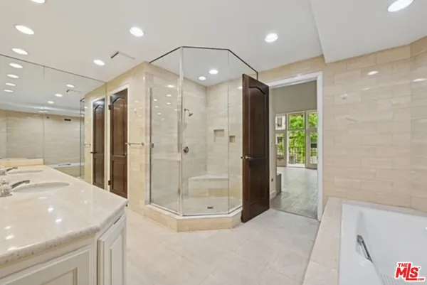 a bathroom with a glass shower door and a sink