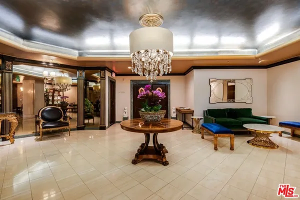 a view of a lobby with a chandelier and living room