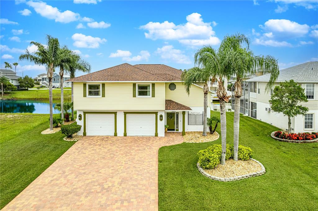 a front view of a house with a yard and garage