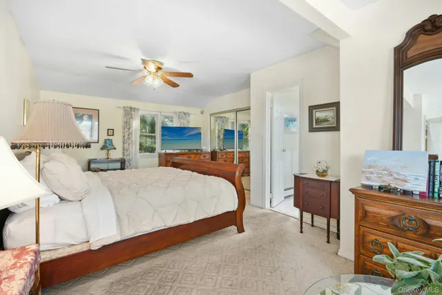 a bedroom with a bed and wooden cabinets