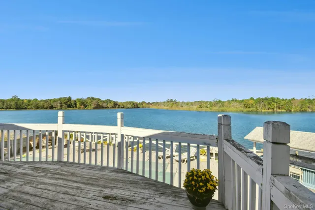 a view of a lake with chairs