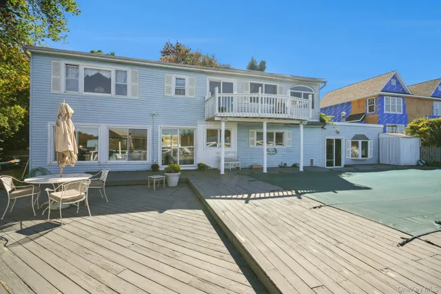 a view of a roof deck with table and chairs
