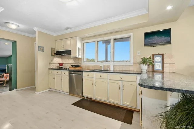 a kitchen with granite countertop white cabinets and white appliances
