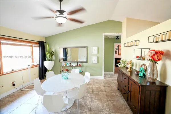 a dining room with furniture and window