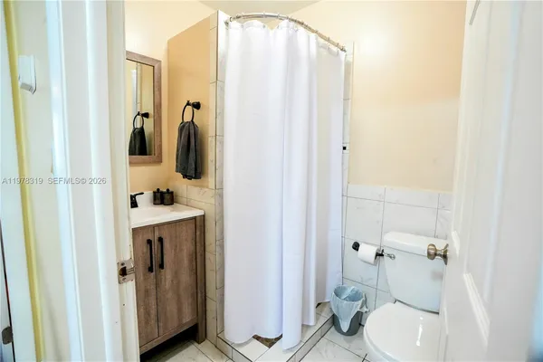 a bathroom with a shower and toilet