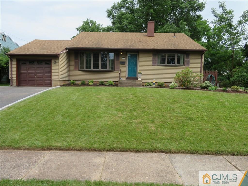 50 Hickory Road Colonia, NJ 07067 - Photo 1 of 16 a front view of a house with a garden