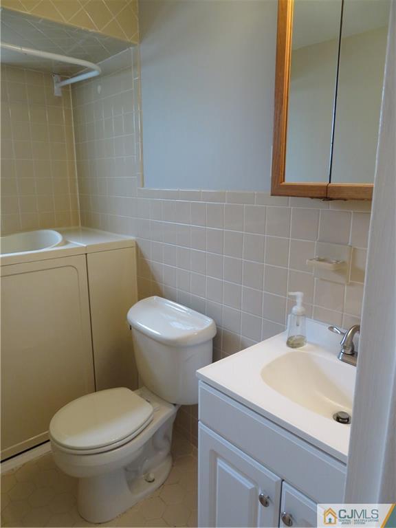 50 Hickory Road Colonia, NJ 07067 - Photo 16 of 16 a bathroom with a sink a toilet and a mirror