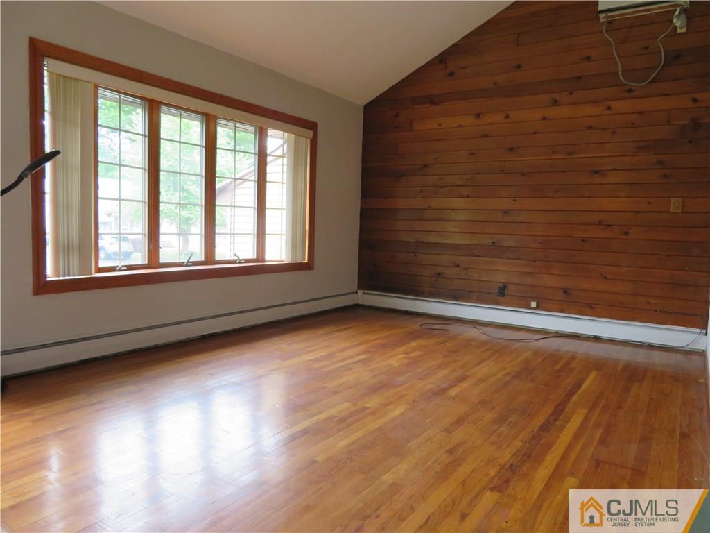 50 Hickory Road Colonia, NJ 07067 - Photo 4 of 16 an empty room with wooden floor and windows