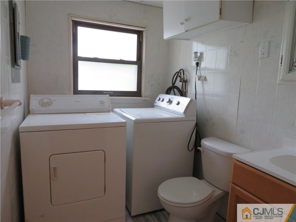 50 Hickory Road Colonia, NJ 07067 - Photo 9 of 16 a bathroom with a toilet sink and window