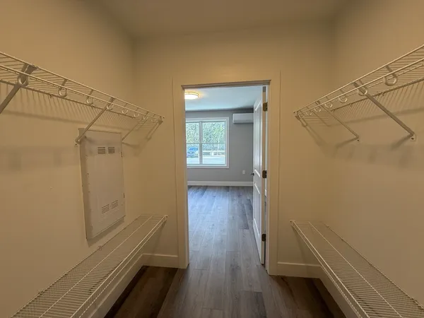 a view of a room with wooden floor and a window