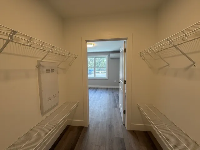 a view of a room with wooden floor and a window