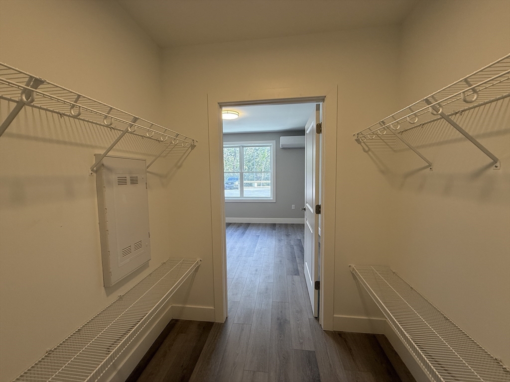 251 Sladen Street, Unit 103 Dracut, MA 01826 - Photo 11 of 27 a view of a room with wooden floor and a window