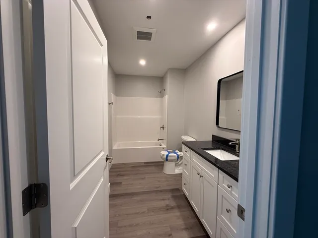 a kitchen with a sink and white cabinets