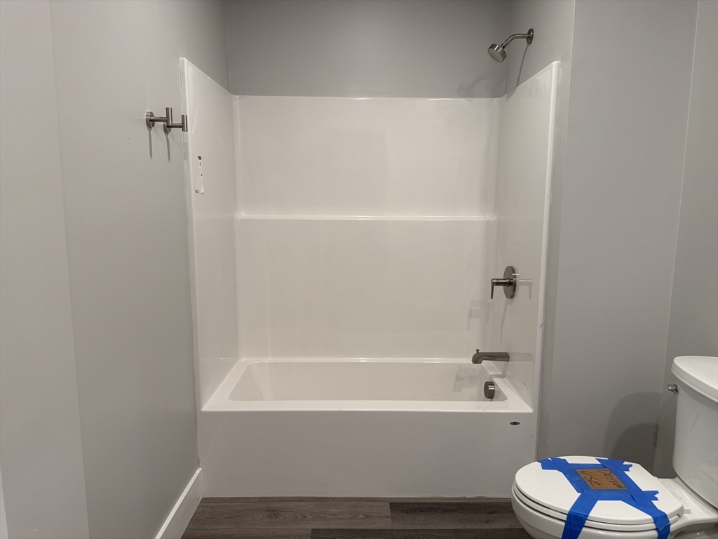 251 Sladen Street, Unit 103 Dracut, MA 01826 - Photo 13 of 27 a bathroom with a bathtub toilet and sink