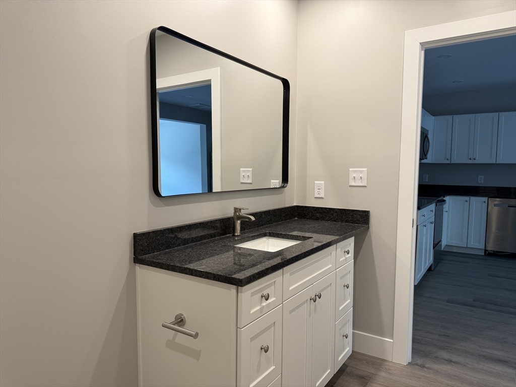251 Sladen Street, Unit 103 Dracut, MA 01826 - Photo 15 of 27 a bathroom with a sink and a mirror