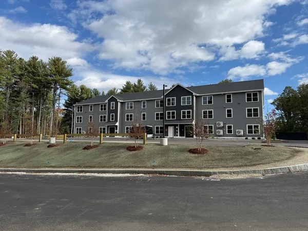 a view of a large building next to a yard