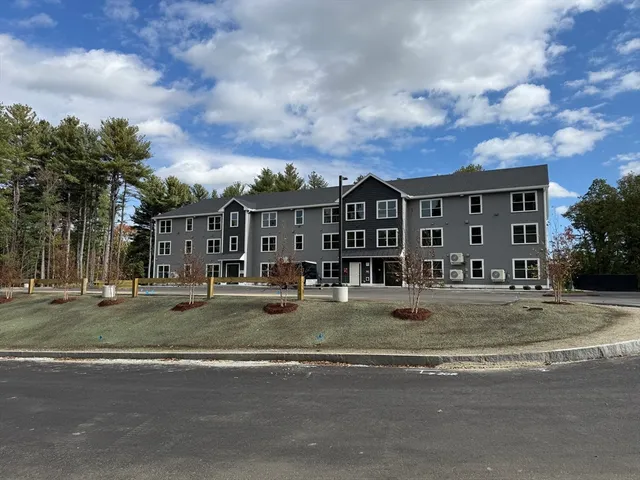 a view of a large building next to a yard