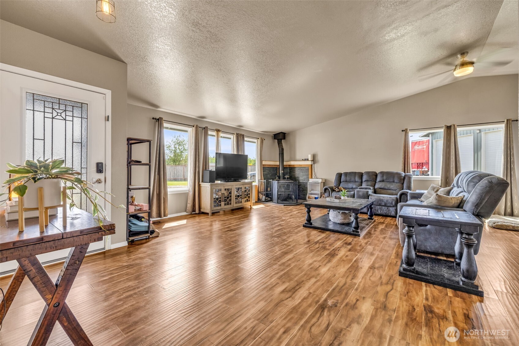 10313 School Land Road Southwest Rochester, WA 98579 - Photo 21 of 40 a living room with furniture and a wooden floor