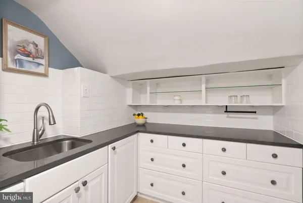 a kitchen with cabinets appliances and a sink
