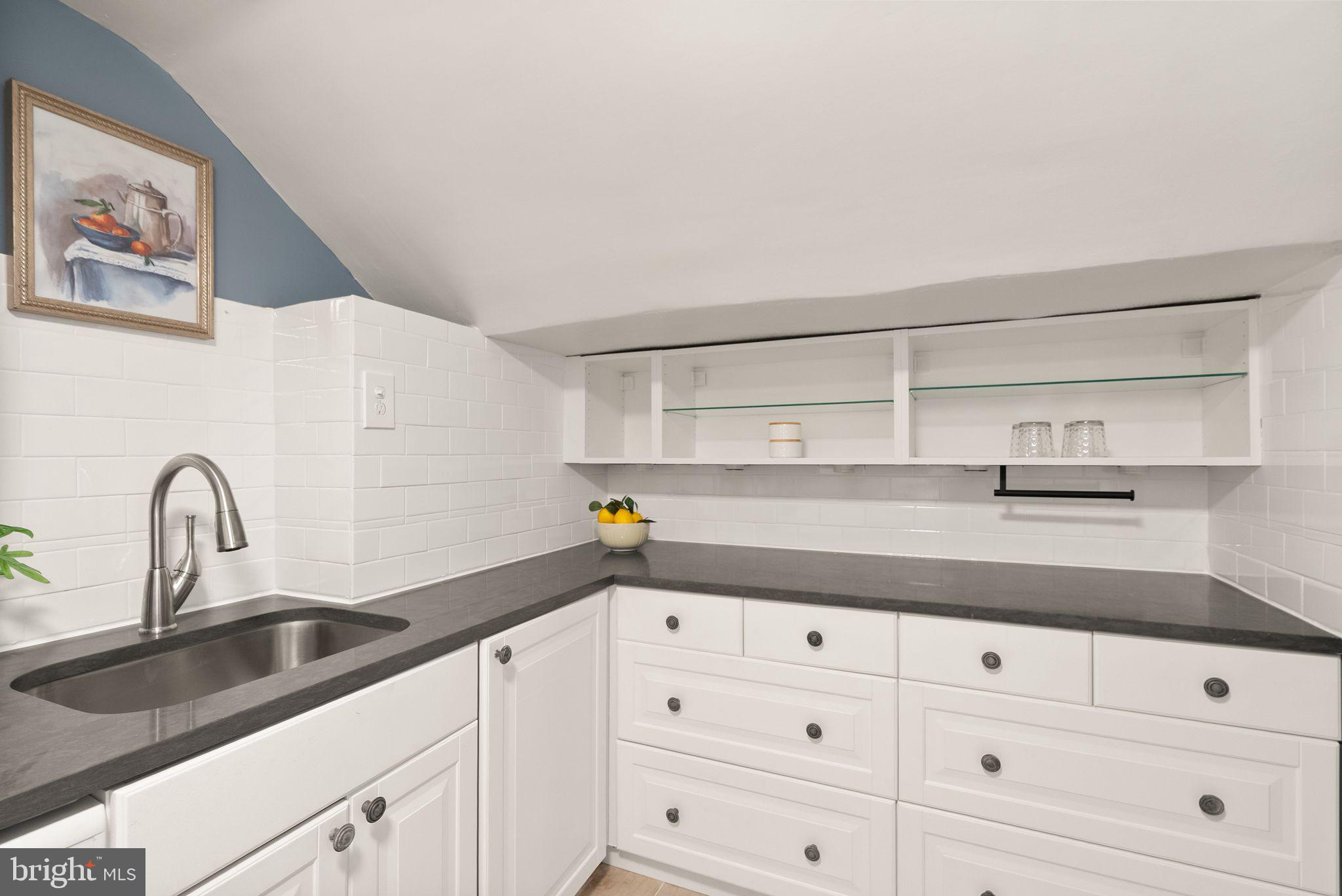 3039 Macomb Street Northwest, Unit 2A Washington, DC 20008 - Photo 11 of 30 a kitchen with cabinets appliances and a sink
