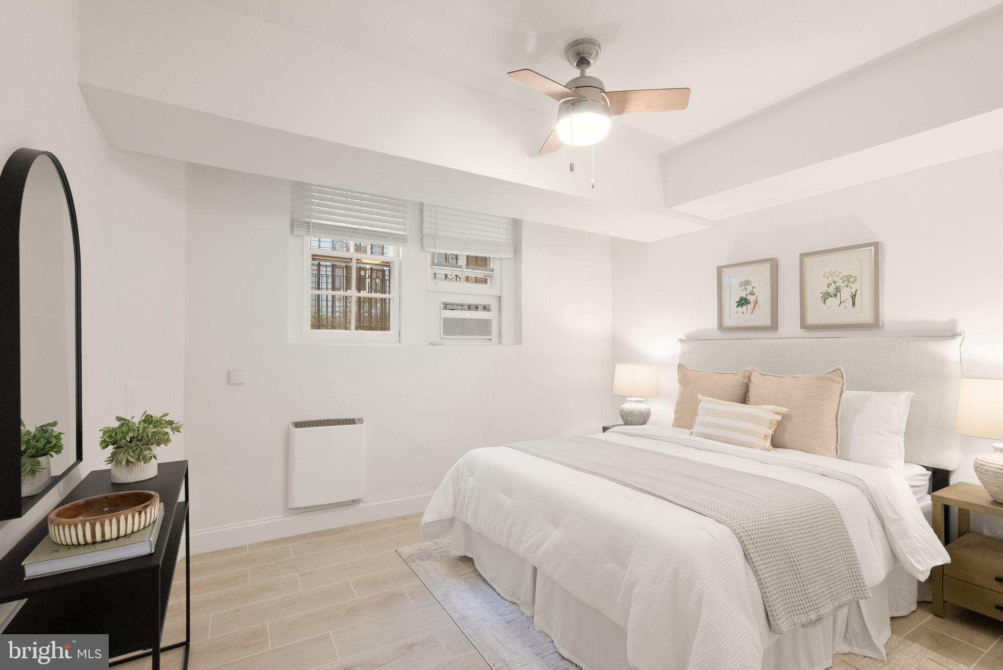 3039 Macomb Street Northwest, Unit 2A Washington, DC 20008 - Photo 12 of 30 a bedroom with a bed and a chandelier