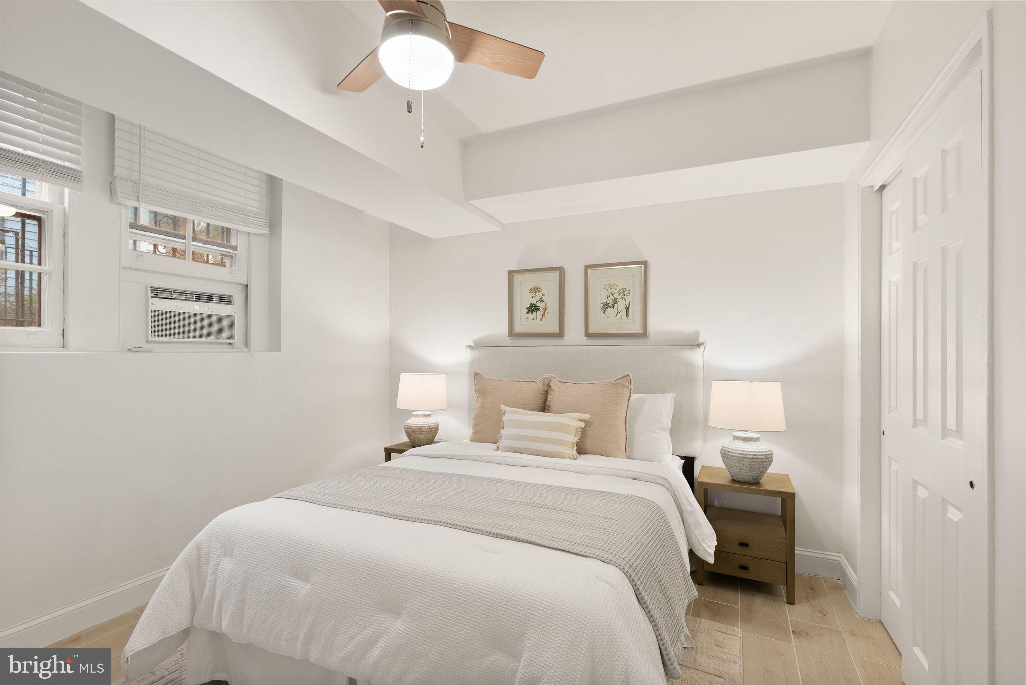 3039 Macomb Street Northwest, Unit 2A Washington, DC 20008 - Photo 13 of 30 a bedroom with a bed and a chandelier