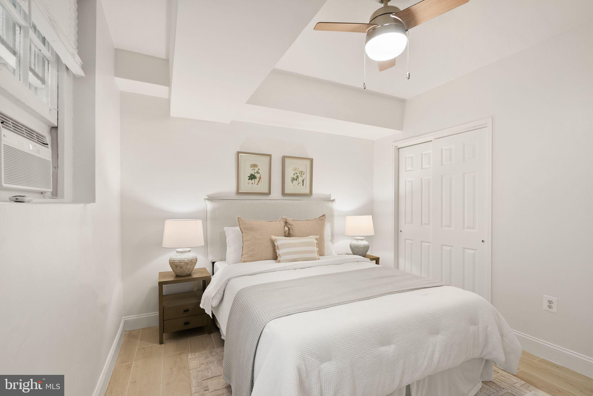 3039 Macomb Street Northwest, Unit 2A Washington, DC 20008 - Photo 14 of 30 a bedroom with a bed and a chandelier