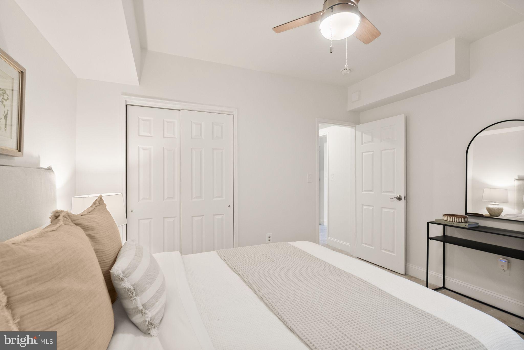 3039 Macomb Street Northwest, Unit 2A Washington, DC 20008 - Photo 15 of 30 a bedroom with a bed and a chandelier