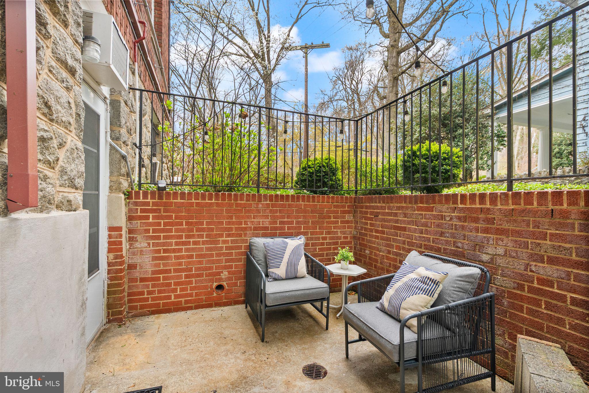 3039 Macomb Street Northwest, Unit 2A Washington, DC 20008 - Photo 18 of 30 a view of a chairs and table in the back yard of the house