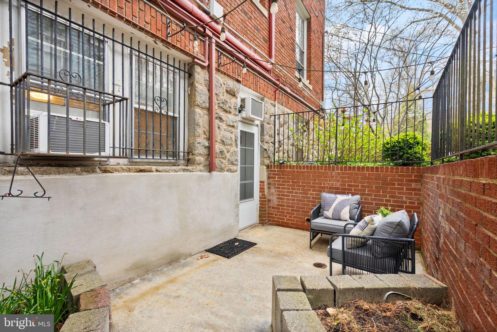 3039 Macomb Street Northwest, Unit 2A Washington, DC 20008 - Photo 19 of 30 a view of a patio with a table and chairs and a couch