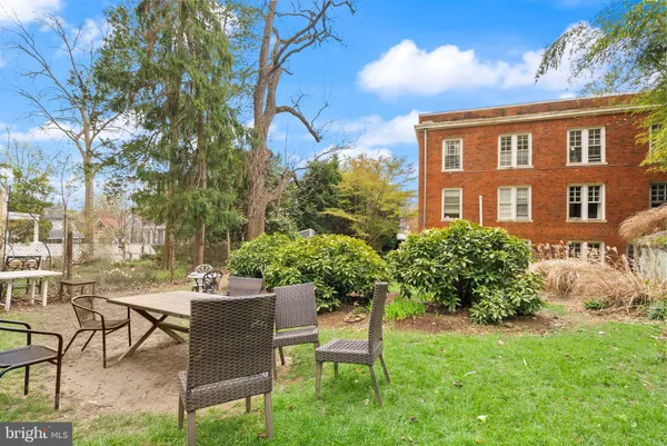 a view of a patio with table and chairs and potted plants