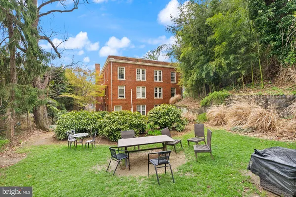 a view of a chairs and table in backyard of the house