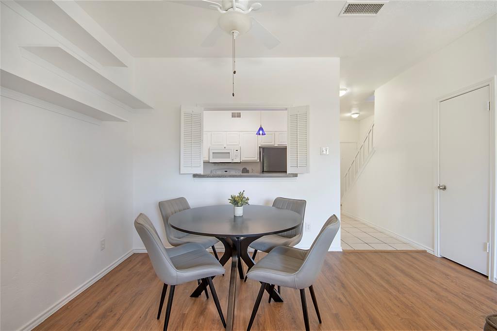 14277 Preston Road, Unit 823 Dallas, TX 75254 - Photo 15 of 31 Dining area featuring wood-finish flooring and a ceiling fan
