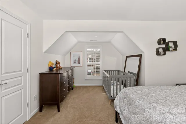 a living room with furniture a flat screen tv and a window