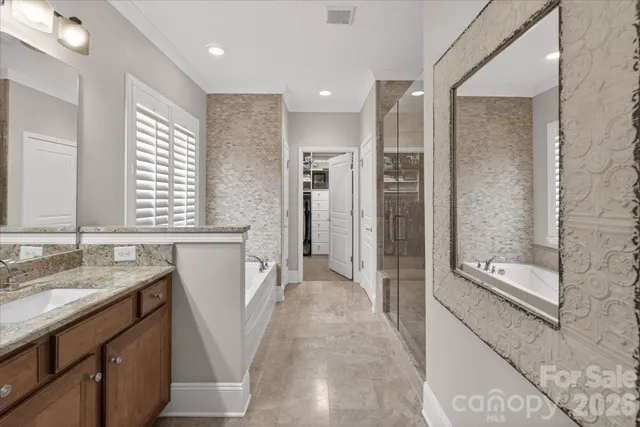 a bathroom with a tub shower and sink